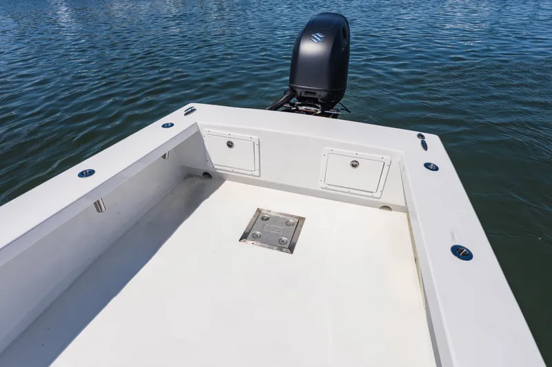 Slide: The Image of 1979 Privateer 20 boat deck with outboard motor on calm water. - 14