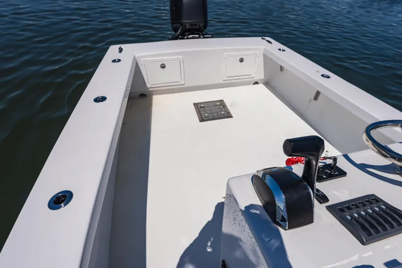 Slide: The Image of 1979 Privateer 20 boat interior with steering controls, on calm water. - 15