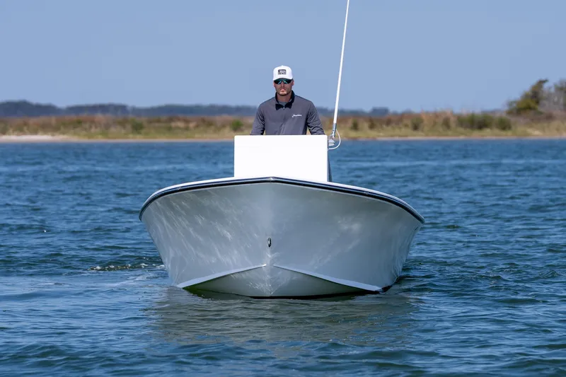Slide: The Image of 1979 Privateer 20 boat on calm water with driver. - 3