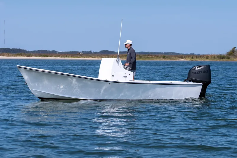 Slide: The Image of 1979 Privateer 20 boat on calm water with Suzuki engine. - 5