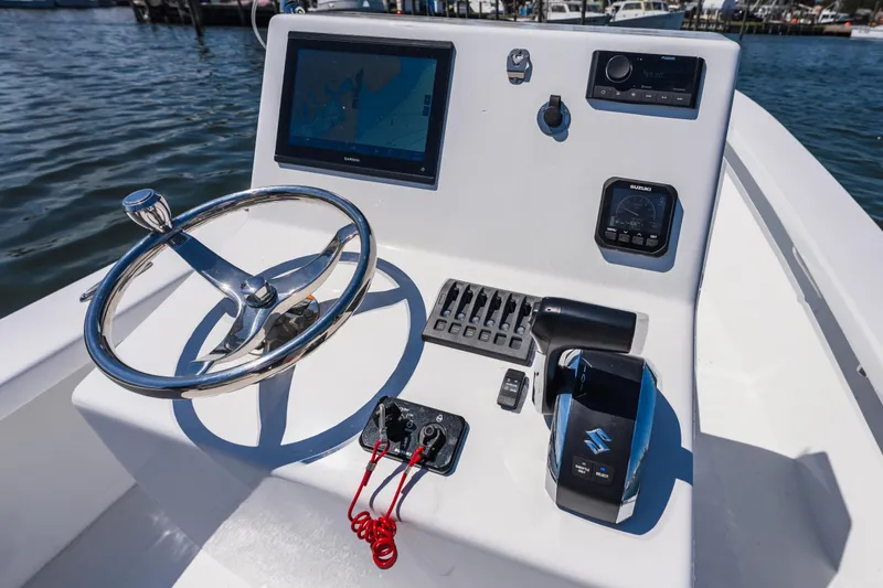 Slide: The Image of 1979 Privateer 20 boat helm with modern electronics and steering wheel. - 7