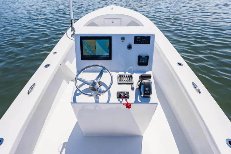 Slide: The Image of Cockpit of a 1979 Privateer 20 boat on calm water. - 9