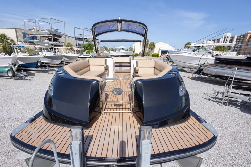 Slide: The Image of 2016 Harris Crowne 250 pontoon boat with sleek design and spacious seating, docked outdoors. - 19