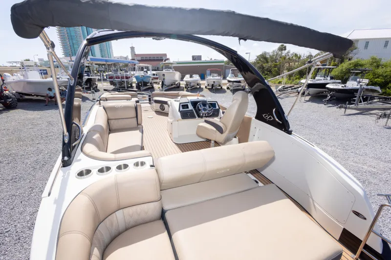 Slide: The Image of 2016 Harris Crowne 250 boat with luxurious seating and modern dashboard in a marina setting. - 21