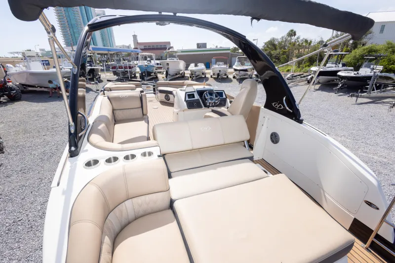 Slide: The Image of 2016 Harris Crowne 250 boat with luxurious seating and modern design in a marina setting. - 24