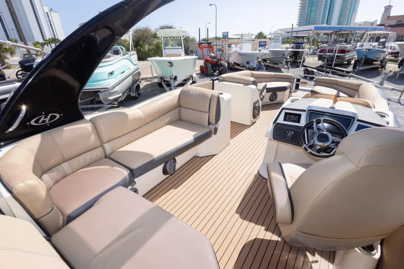 Slide: The Image of Luxurious 2016 Harris Crowne 250 pontoon boat interior with plush seating and modern dashboard. - 25
