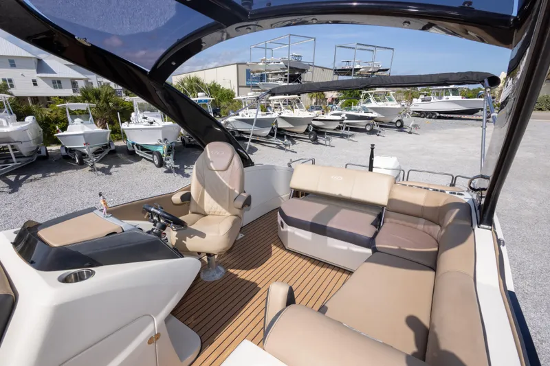 Slide: The Image of Interior of a 2016 Harris Crowne 250 boat with luxurious seating and helm. - 27
