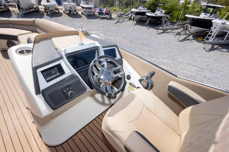 Slide: The Image of 2016 Harris Crowne 250 boat interior with steering wheel and control panel. - 28