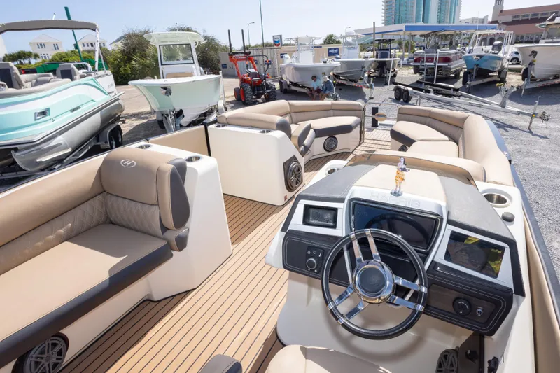 Slide: The Image of 2016 Harris Crowne 250 pontoon boat interior with luxurious seating and modern dashboard. - 29