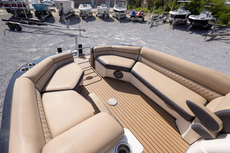 Slide: The Image of Luxurious 2016 Harris Crowne 250 boat interior with tan seating and wood-style flooring. - 31