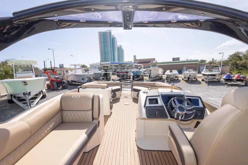 Slide: The Image of Interior view of a 2016 Harris Crowne 250 boat with luxurious seating and modern dashboard. - 38