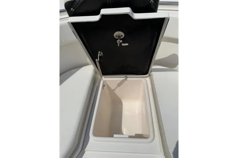 Slide: The Image of Open storage compartment on 2015 Robalo R300 Center Console boat. - 13