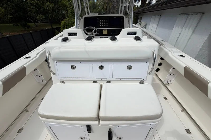 Slide: The Image of 2015 Robalo R300 Center Console boat interior with seating and control panel. - 16