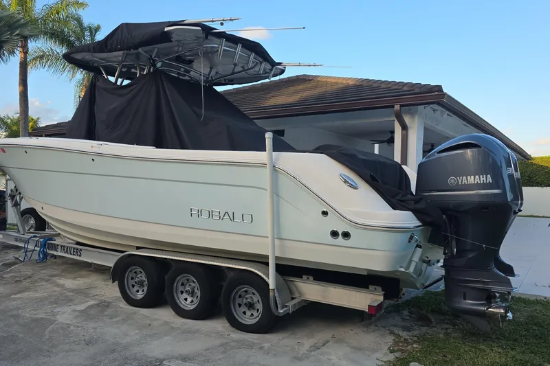 Slide: The Image of 2015 Robalo R300 Center Console boat on trailer with Yamaha engine. - 2