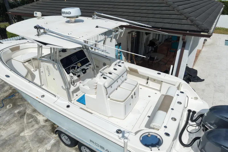 Slide: The Image of 2015 Robalo R300 Center Console boat with dual engines, spacious deck, and advanced navigation system. - 3