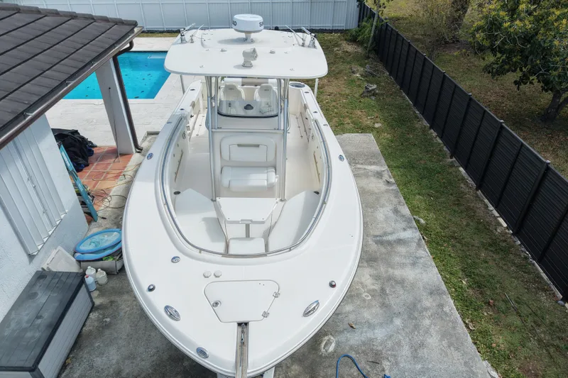 Slide: The Image of 2015 Robalo R300 Center Console boat parked near a pool, aerial view. - 4