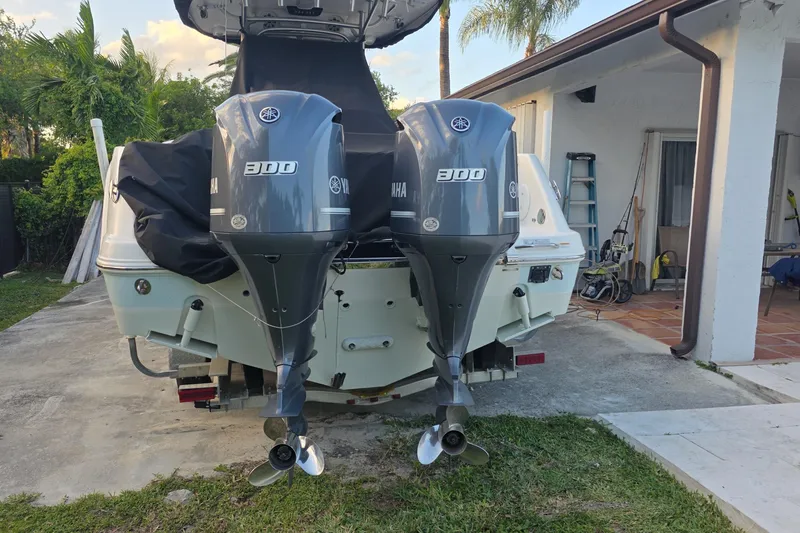 Slide: The Image of 2015 Robalo R300 Center Console with twin Yamaha 300 engines, parked outdoors. - 5