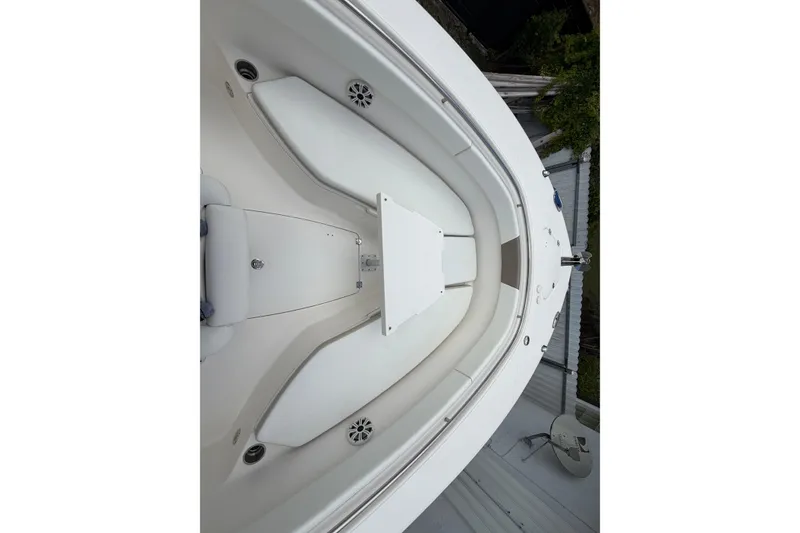 Slide: The Image of 2015 Robalo R300 Center Console boat interior with white seating and speakers. - 7