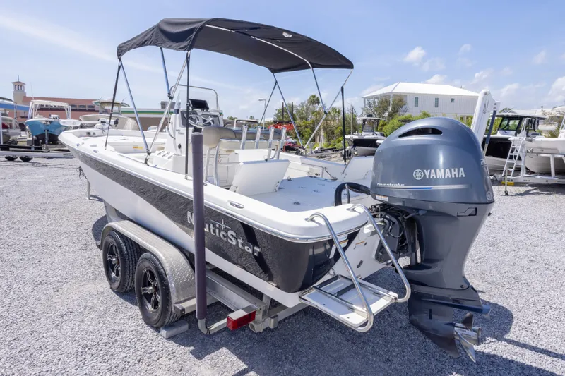 Slide: The Image of 2017 NauticStar 2400 Sport boat with Yamaha engine on trailer, outdoor display. - 10