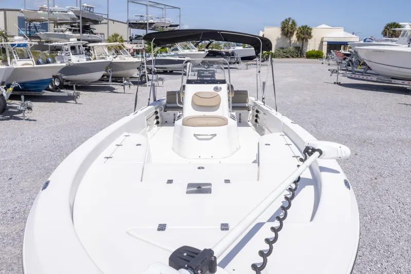 Slide: The Image of 2017 NauticStar 2400 Sport boat displayed in a marina with other vessels. - 14