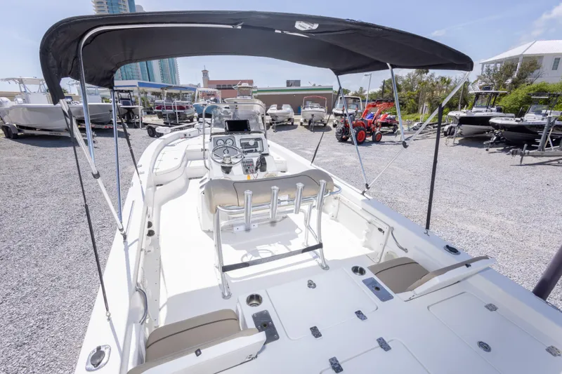 Slide: The Image of 2017 NauticStar 2400 Sport boat with canopy in a marina setting. - 15