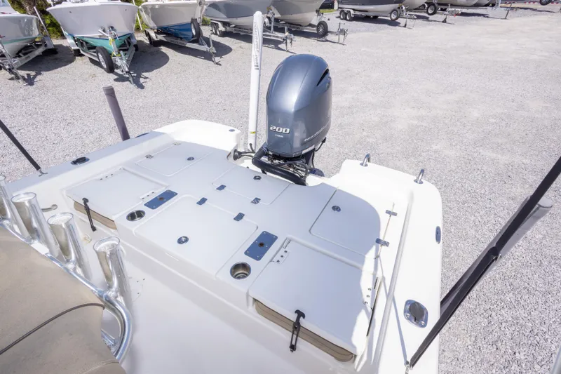 Slide: The Image of 2017 NauticStar 2400 Sport boat with powerful 200 HP engine, parked on gravel lot. - 18