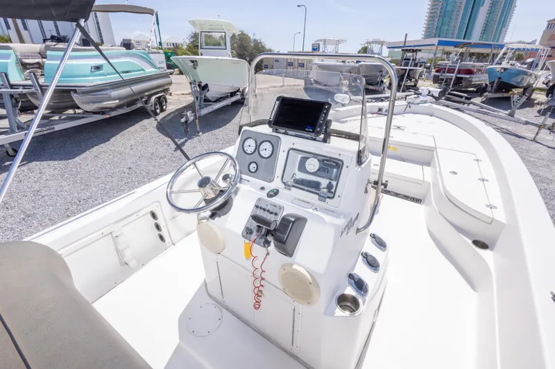 Slide: The Image of 2017 NauticStar 2400 Sport boat interior with steering console and navigation equipment. - 21