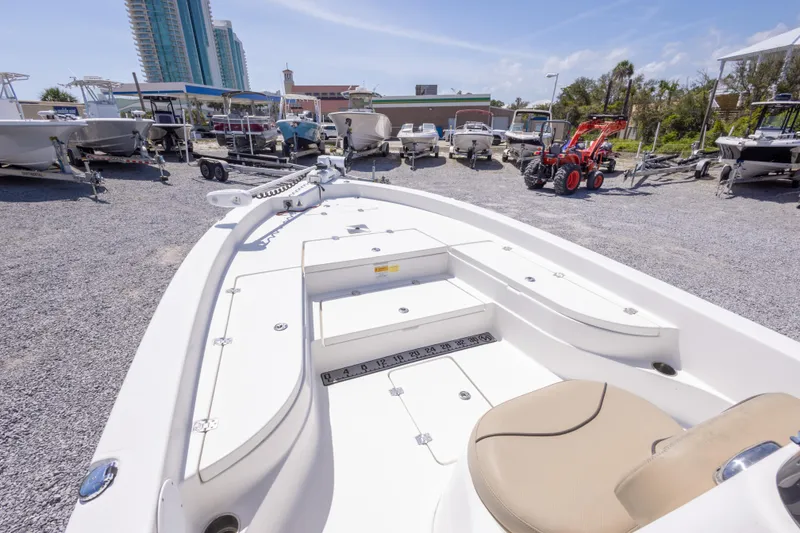 Slide: The Image of 2017 NauticStar 2400 Sport boat displayed in a marina with other vessels. - 27