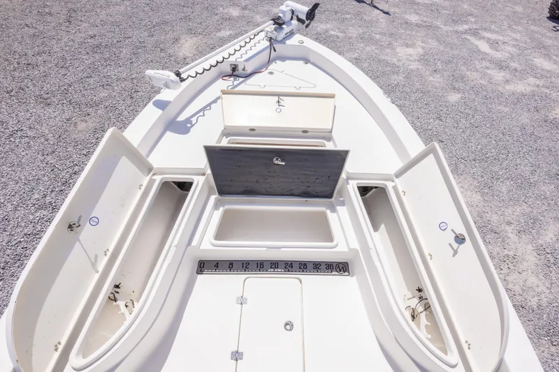 Slide: The Image of 2017 NauticStar 2400 Sport boat deck with storage compartments and measuring ruler. - 30