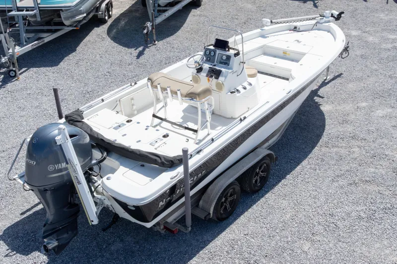 Slide: The Image of 2017 NauticStar 2400 Sport boat with Yamaha engine on trailer, parked on gravel. - 35