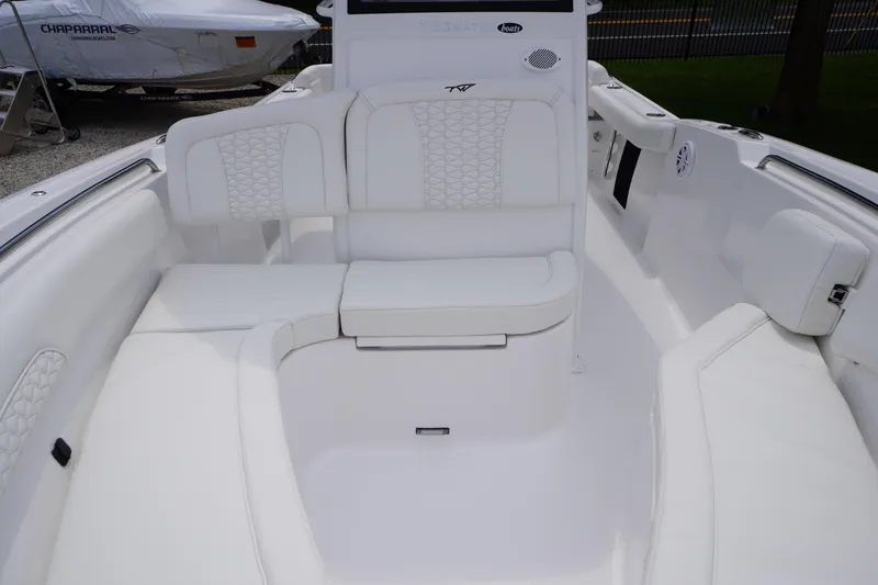 Slide: The Image of 2026 Tidewater 232 SS boat interior with white cushioned seating. - 11