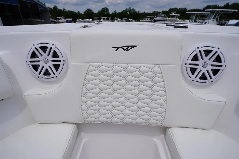 Slide: The Image of 2026 Tidewater 232 SS boat interior with white quilted seating and JL Audio speakers. - 15