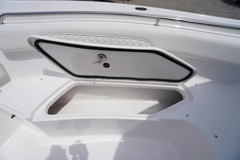 Slide: The Image of 2026 Tidewater 232 SS boat storage compartment with open hatch and key lock. - 20