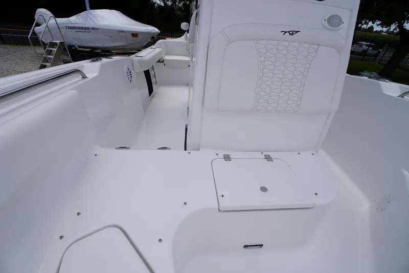 Slide: The Image of 2026 Tidewater 232 SS boat interior with white seating and storage compartment. - 22