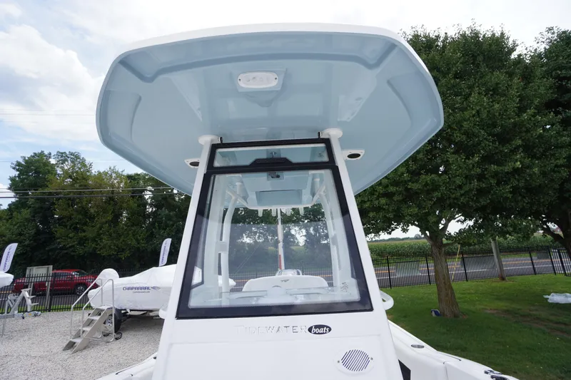 Slide: The Image of 2026 Tidewater 232 SS boat with T-top, displayed outdoors. - 25