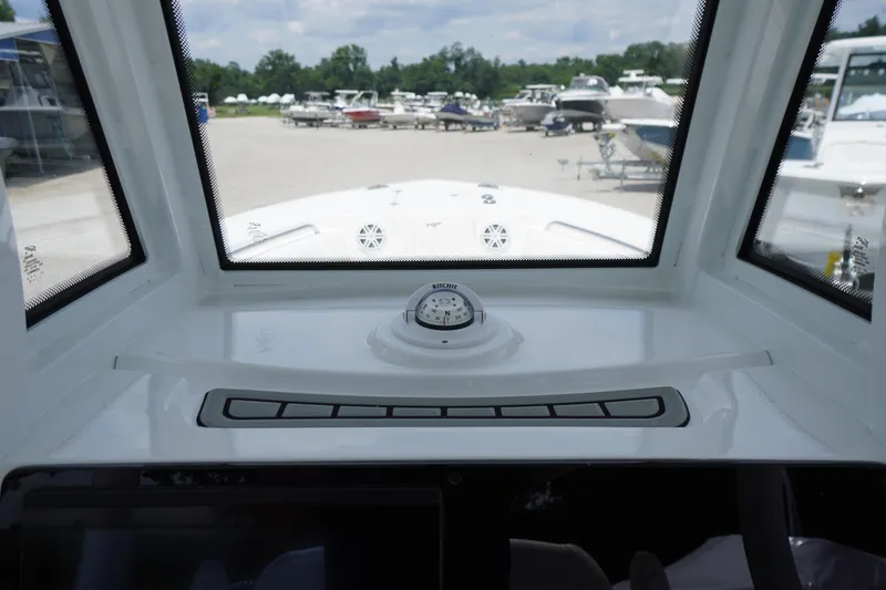 Slide: The Image of Interior view of 2026 Tidewater 232 SS boat cockpit with compass and windshield. - 35