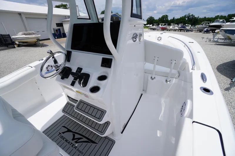 Slide: The Image of 2026 Tidewater 232 SS boat interior with steering console and seating area. - 37