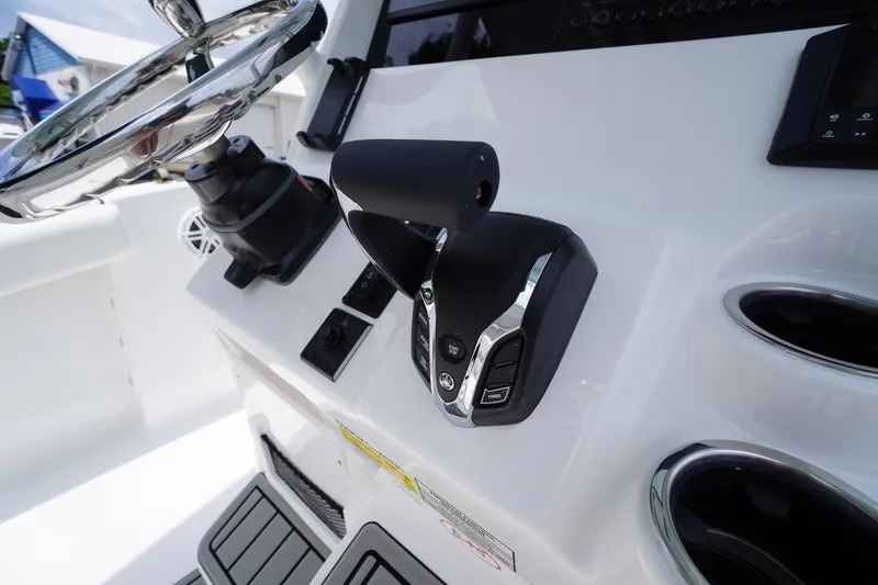 Slide: The Image of 2026 Tidewater 232 SS boat console with steering wheel and controls. - 38