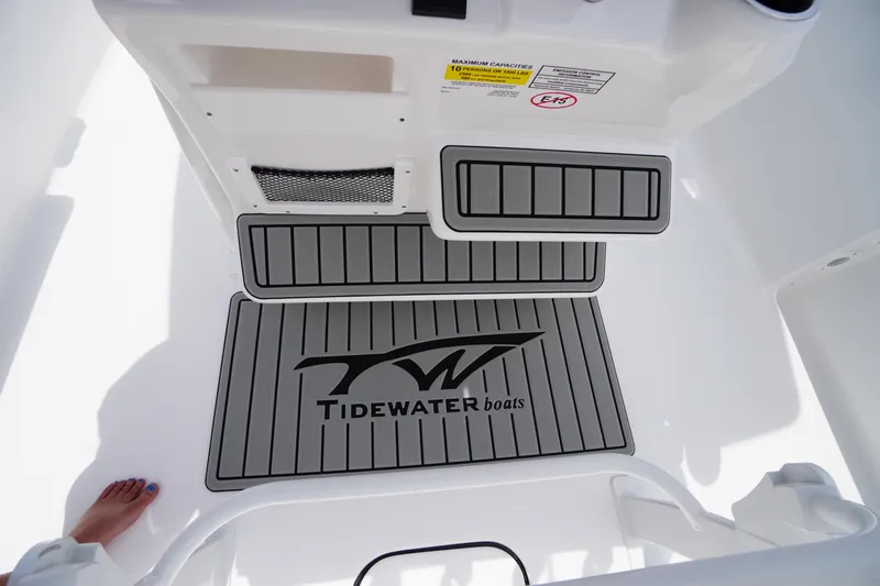 Slide: The Image of 2026 Tidewater 232 SS boat interior with branded flooring and footrest. - 40