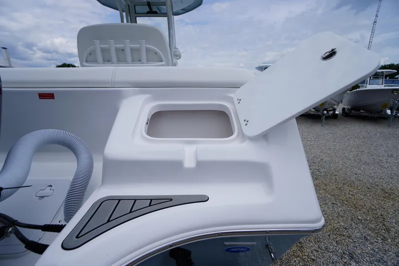 Slide: The Image of 2026 Tidewater 232 SS boat with open storage compartment, showcasing sleek design and functionality. - 61