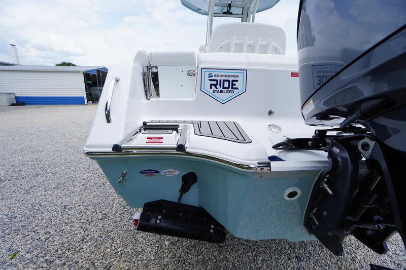 Slide: The Image of 2026 Tidewater 232 SS boat with Seakeeper Ride stabilization, rear view on gravel surface. - 73