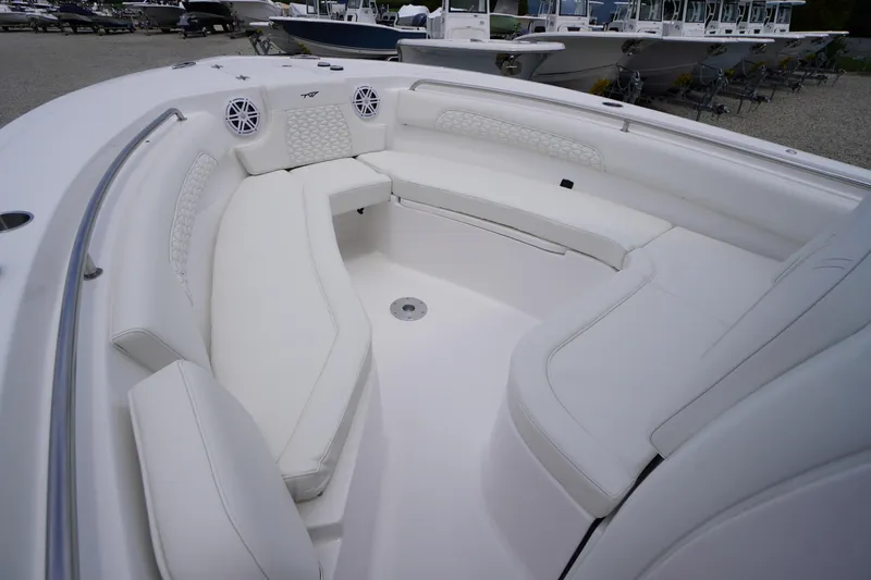 Slide: The Image of 2026 Tidewater 232 SS boat interior with white cushioned seating and speakers. - 9