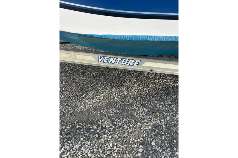 Slide: The Image of Trailer with "Venture" logo under a 2011 Carolina Skiff 258 DLV boat. - 12