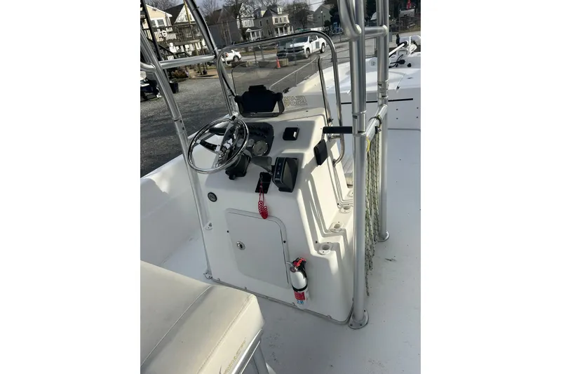 Slide: The Image of 2011 Carolina Skiff 258 DLV boat console with steering wheel and controls. - 4