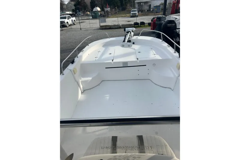 Slide: The Image of 2011 Carolina Skiff 258 DLV boat interior, featuring spacious deck and seating area. - 7