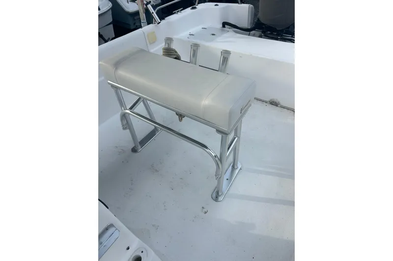 Slide: The Image of 2011 Carolina Skiff 258 DLV boat interior with cushioned bench seat and metal frame. - 8