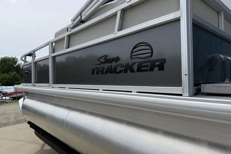 Slide: The Image of 2026 Sun Tracker Bass Buggy 16 XL Select pontoon boat, side view with logo. - 10