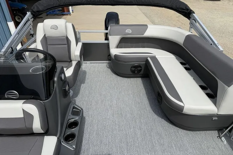 Slide: The Image of 2026 Sun Tracker Bass Buggy 16 XL Select pontoon boat interior with gray seating and helm. - 12