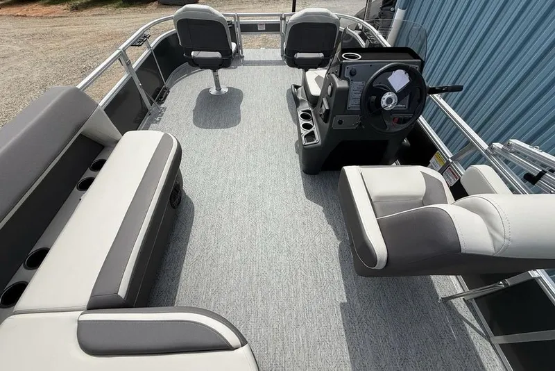 Slide: The Image of 2026 Sun Tracker Bass Buggy 16 XL Select pontoon boat interior with seating and steering console. - 26