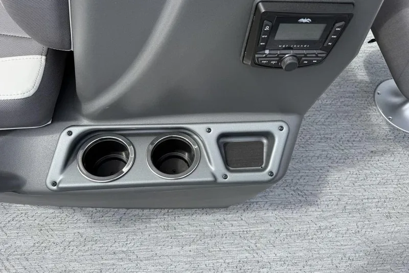 Slide: The Image of 2026 Sun Tracker Bass Buggy 16 XL Select console with cup holders and audio controls. - 28